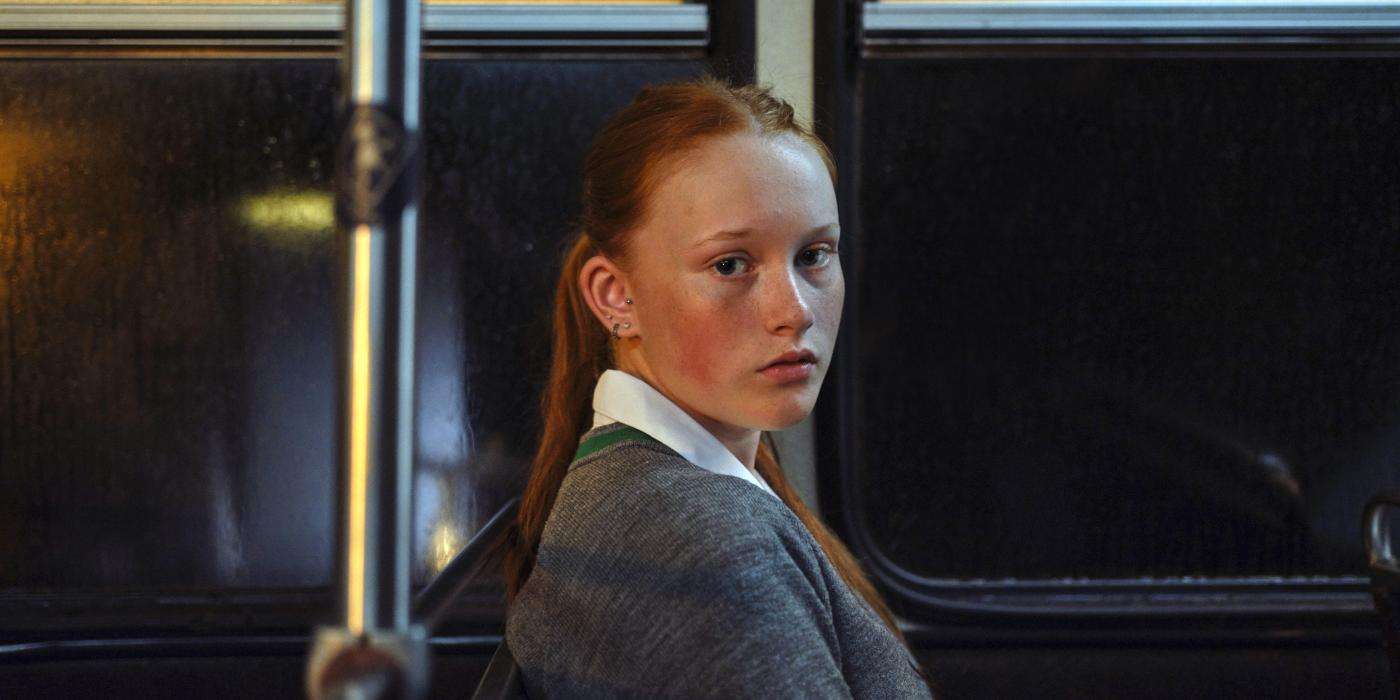 Girl on a bus looking at camera